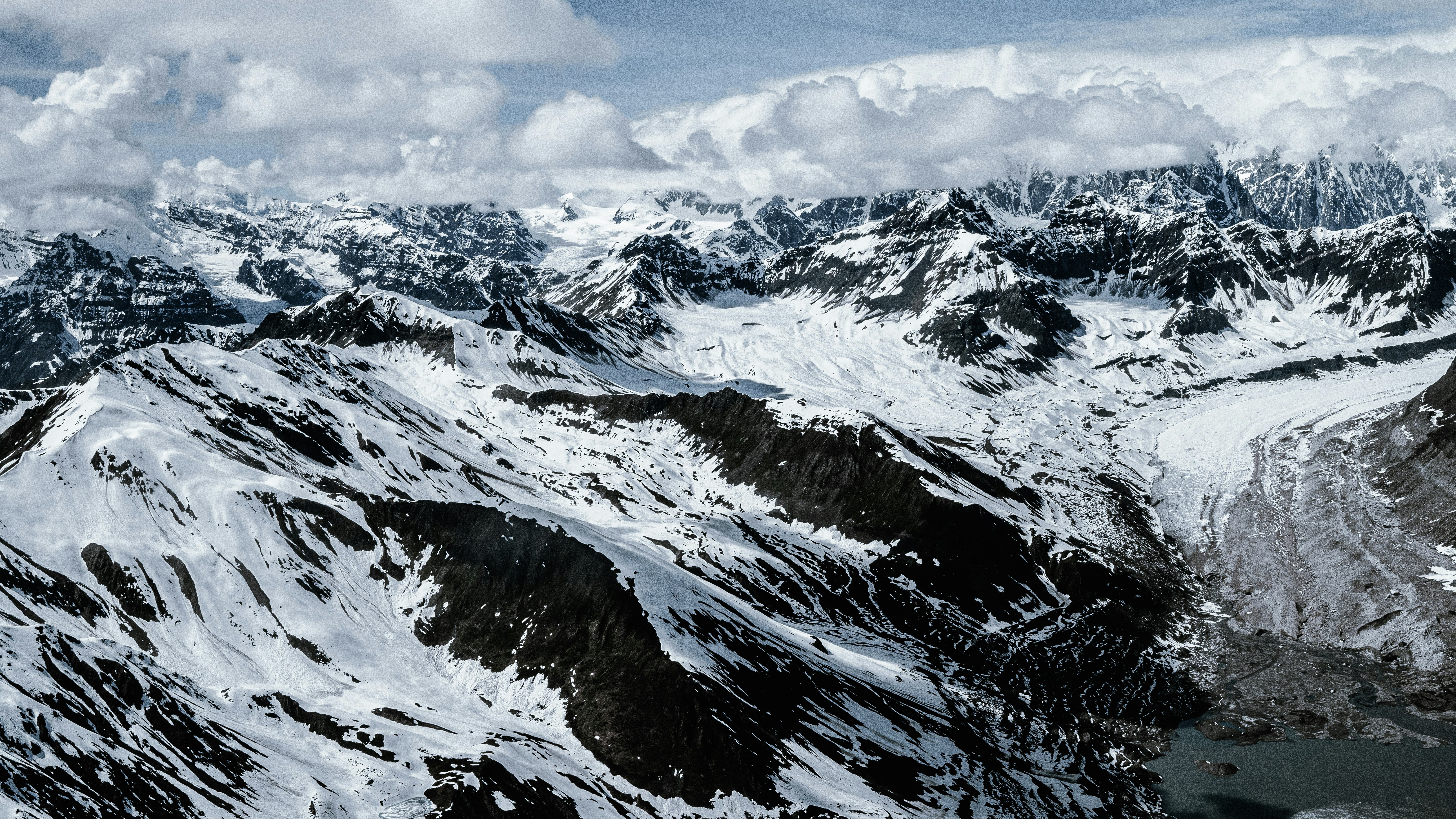 black and white mountain under white clouds during daytime